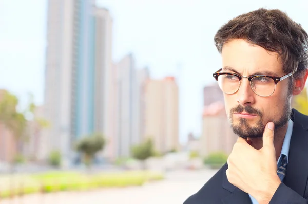 Young crazy businessman thinking — Stock Photo, Image