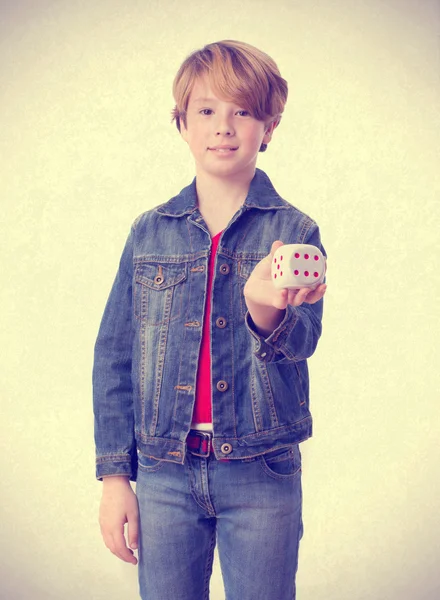 Happy child holding a die — Stock Photo, Image