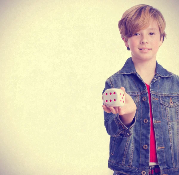 Happy child holding a die — Stock Photo, Image