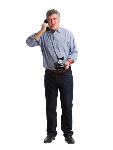 Angry businessman with a telephone — Stock Photo, Image