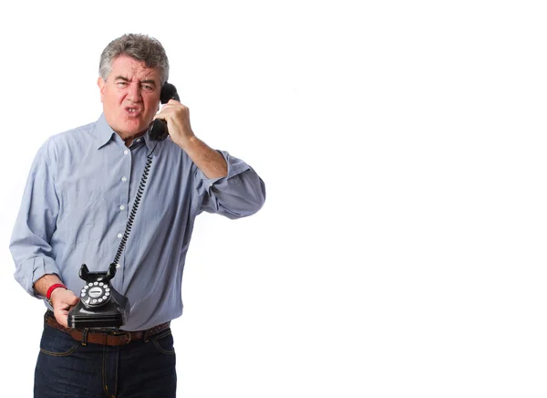 Angry man holding a telephone — Stock Photo, Image