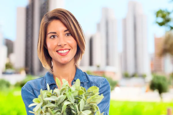 Young cool woman with a plant — Stock Photo, Image