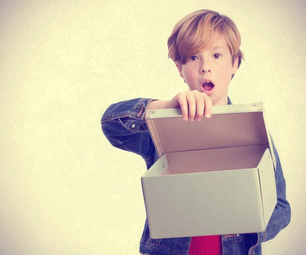 Surprised child opening a box — Stock Photo, Image