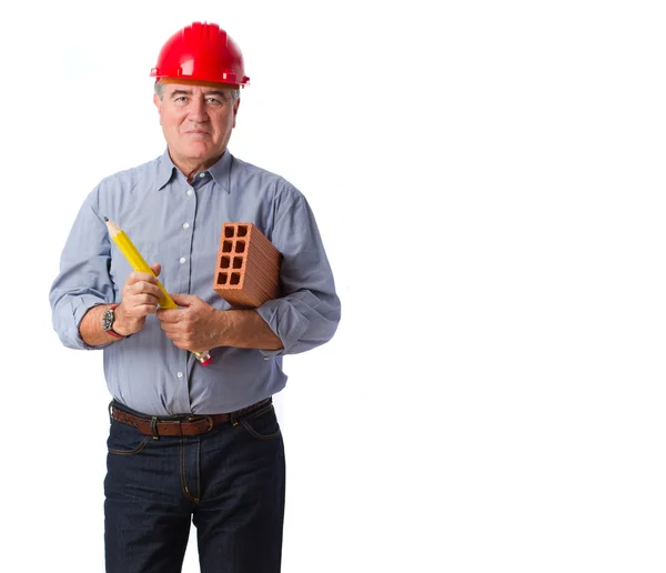 Homme avec une brique et un crayon — Photo