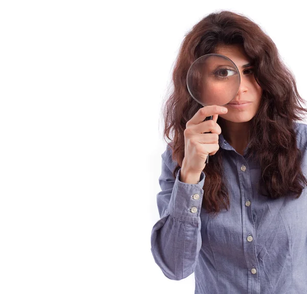 Girl observing with a magnifying glass — Stock Photo, Image