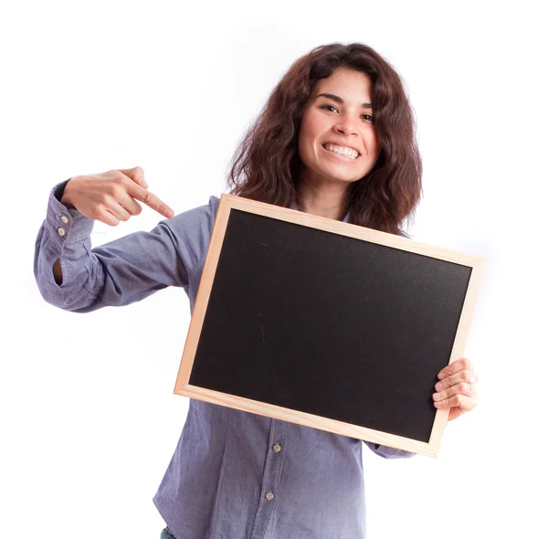 Menina feliz apontando para um quadro negro — Fotografia de Stock