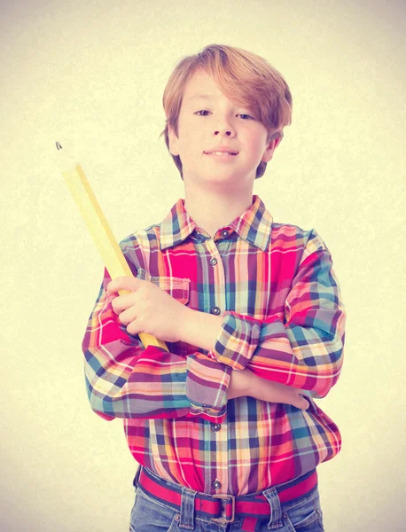 Satisfied child holding a pencil — Stock Photo, Image