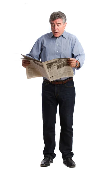 Angry man reading a newspaper — Stock Photo, Image