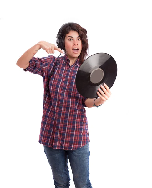 Menina surpreendida com um fone de ouvido e um vinil — Fotografia de Stock