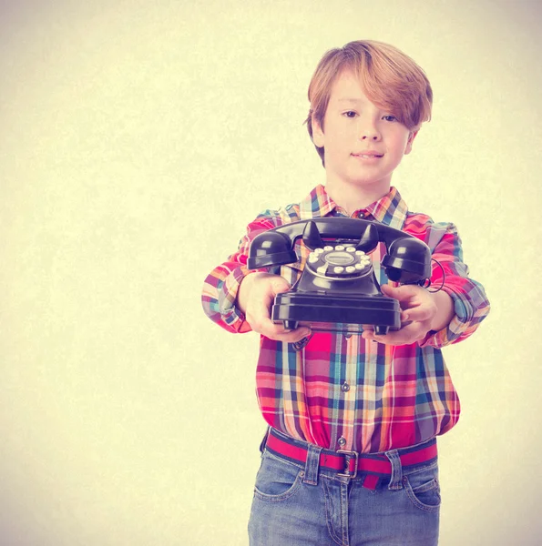 Happy boy offering a phone — Stock Photo, Image