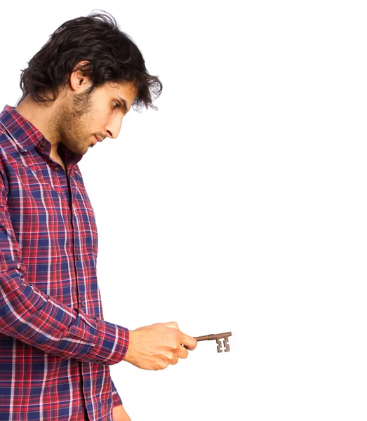 Hindu cool young man opening with a key — Stock Photo, Image