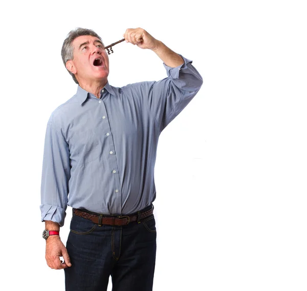 Man swallowing a key — Stock Photo, Image