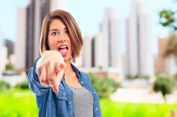 Young cool woman pointing — Stock Photo, Image