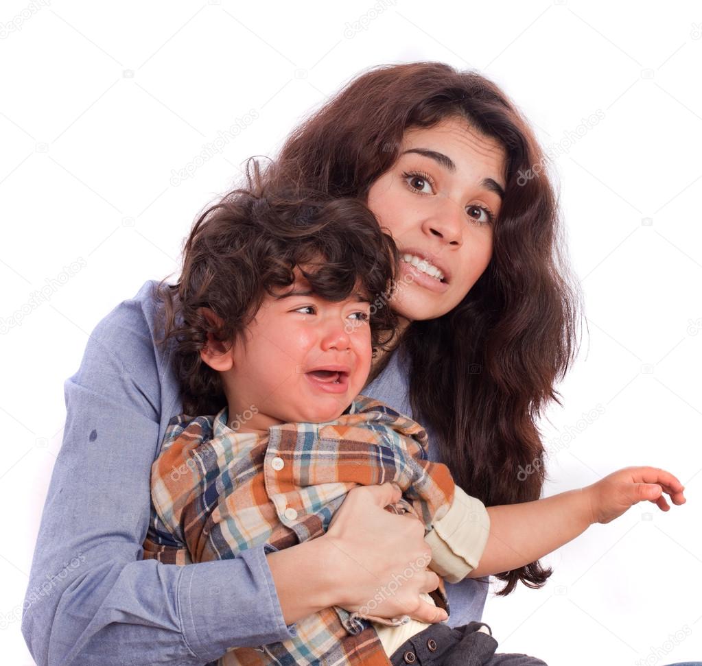 Concerned girl holding her weepy son