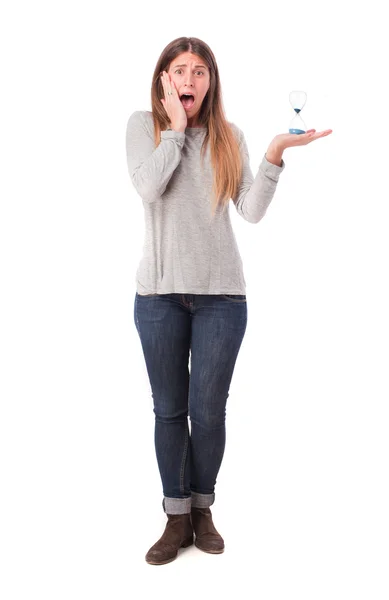 Worried girl holding an hourglass — Stock Photo, Image