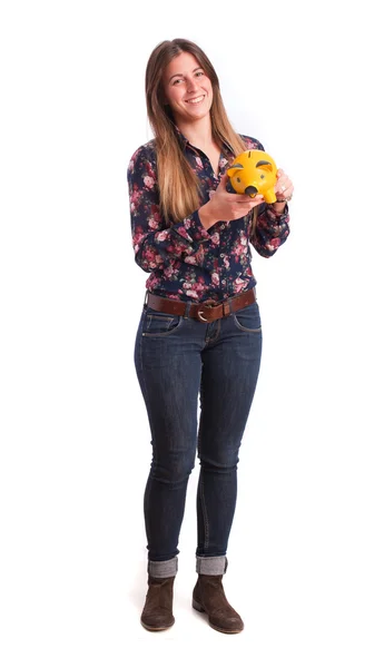 Satisfied girl holding a piggy bank — Stock Photo, Image