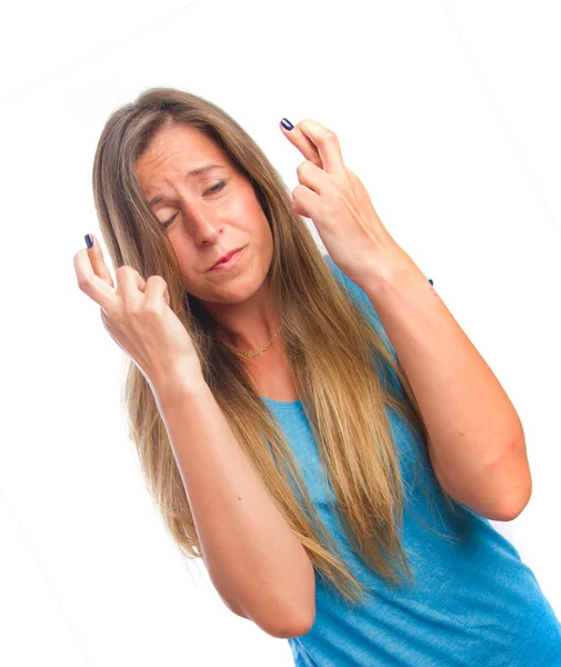 Nadenkend meisje vinger gekruist gebaar — Stockfoto