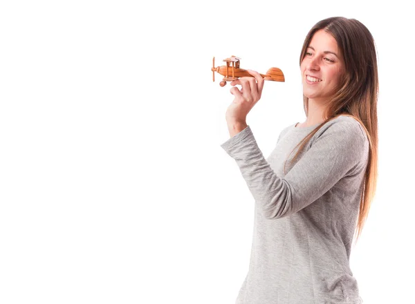 Šťastná dívka drží dřevěné letadlo — Stock fotografie