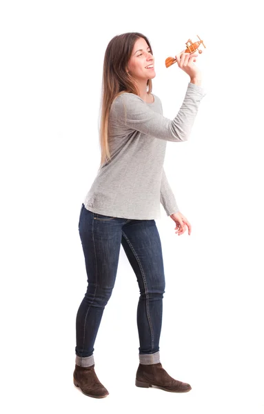 Girl throwing a wood plane — Stock Photo, Image