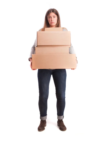 Worried girl holding a weighty cardboard boxes — Stock Photo, Image