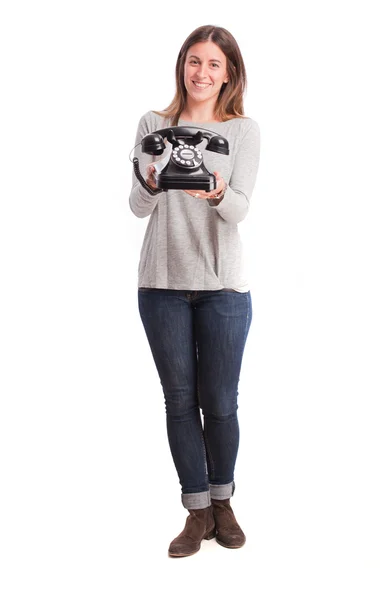 Flicka som håller en telefon — Stockfoto