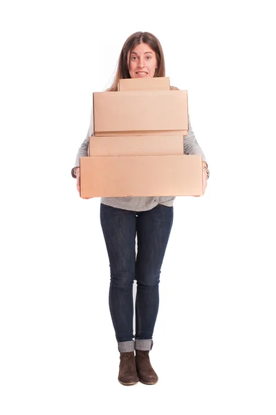 Satisfied girl holding a weighty cardboard boxes — Stock Photo, Image