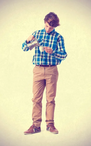 Teenager serving a cup of coffee — Stock Photo, Image