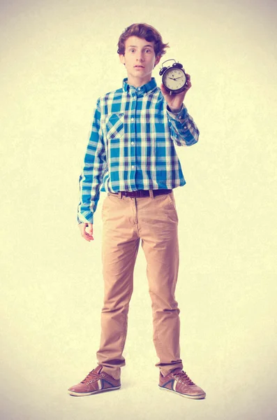 Teenager holding an alarm clock — Stock Photo, Image