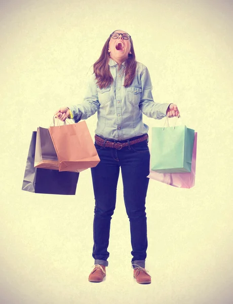 Shouting girl with shopping bags. isolated — Stock Photo, Image