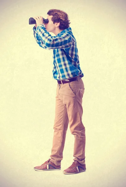 Teenager looking for a binoculars — Stock Photo, Image