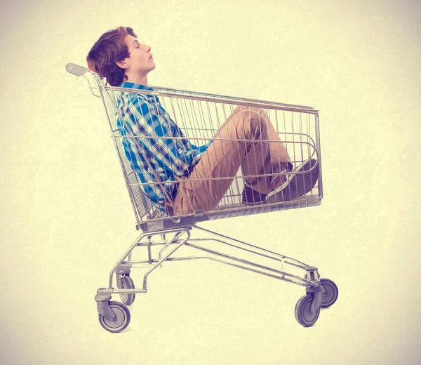 Teenager inside a shopping cart — Stock Photo, Image