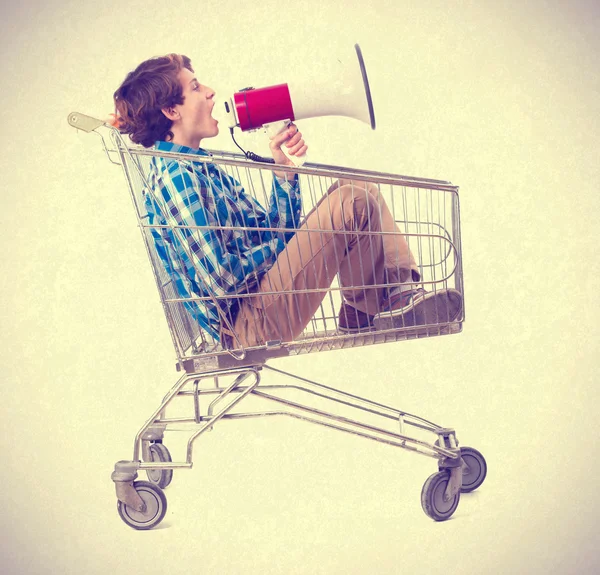Tiener met megafoon binnen een trolley — Stockfoto