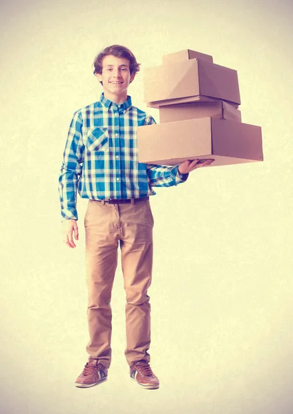 Teenager holding a cardboard boxes — Stock Photo, Image