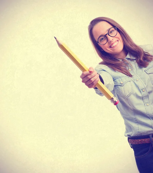 Young woman holding a pencil — Stock Photo, Image