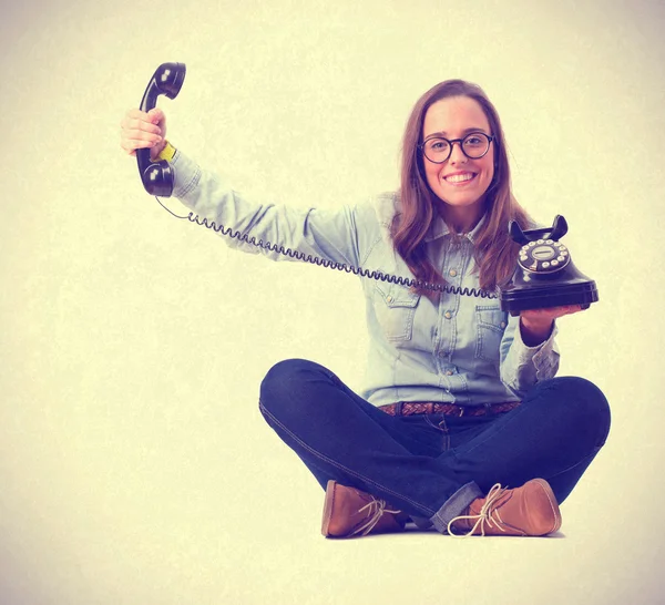 Young woman holding a telephone — Stock Photo, Image