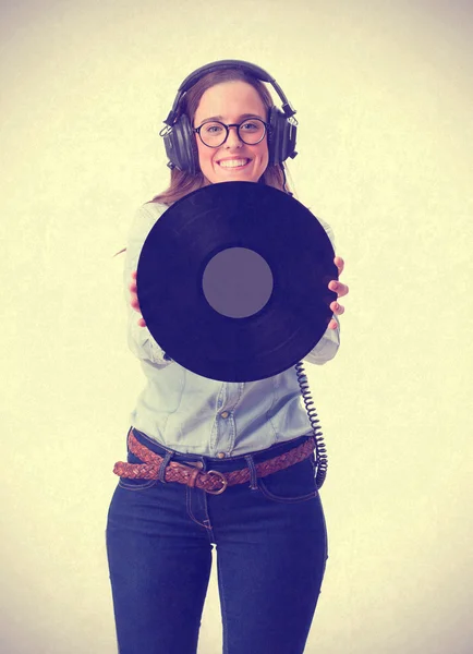 Young girl with headphones and holding a vinyl — Stock Photo, Image