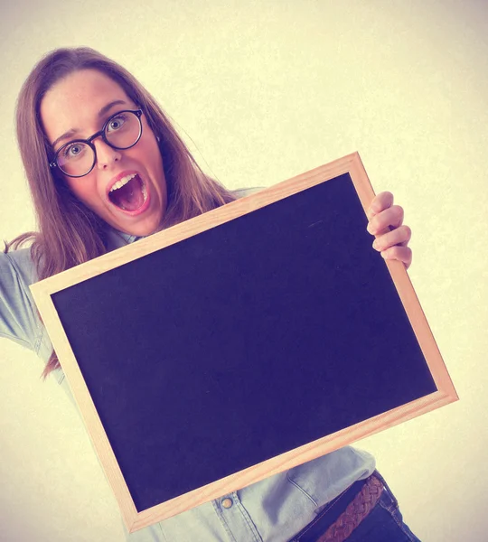 Young woman holding a blackboard — Stock Photo, Image