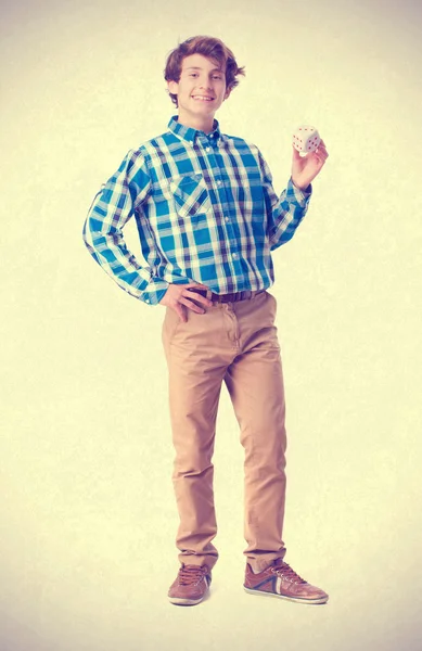 Teenager holding a die — Stock Photo, Image