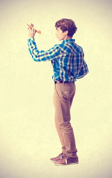 Teenager playing with wood plane — Stock Photo, Image