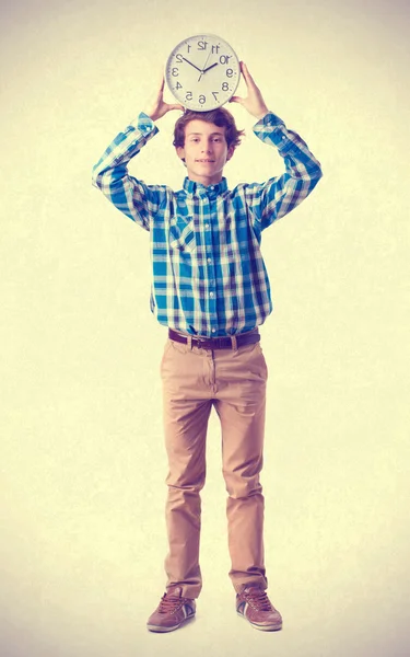 Teenager holding a clock — Stock Photo, Image