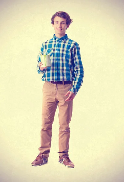 Teenager holding a paint can — Stock Photo, Image