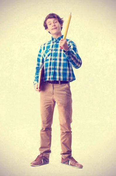 Teenager holding a pencil and notebook — Stock Photo, Image