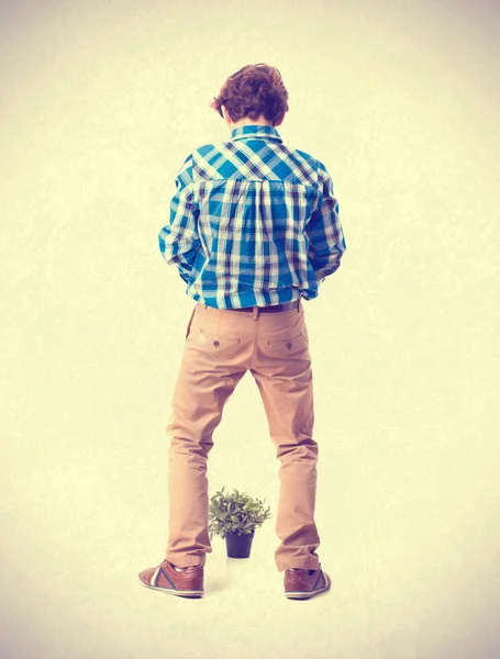 Teenager with plant and urinate gesture — Stock Photo, Image