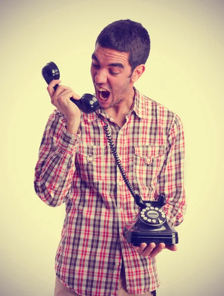 Young man shouting on phone — Stock Photo, Image