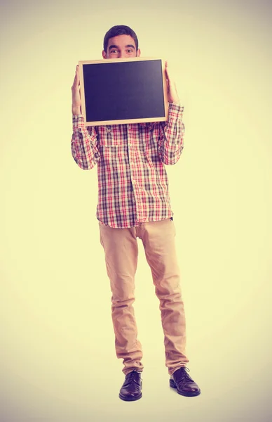 Young man holding a blackboard — Stock Photo, Image
