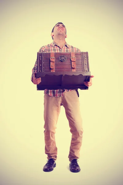 Boy holding a weighty trunk — Stock Photo, Image