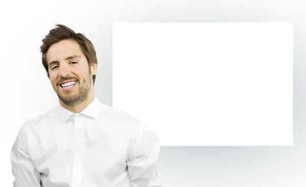 Man smiling on an empty canvas frame — Stock Photo, Image