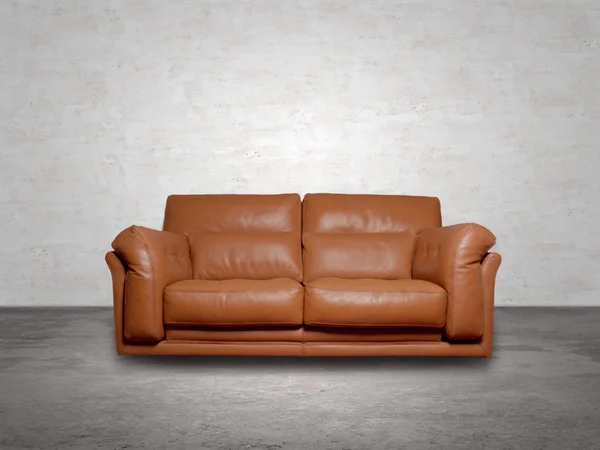 Brown leather sofa into a concrete room — Stock Photo, Image