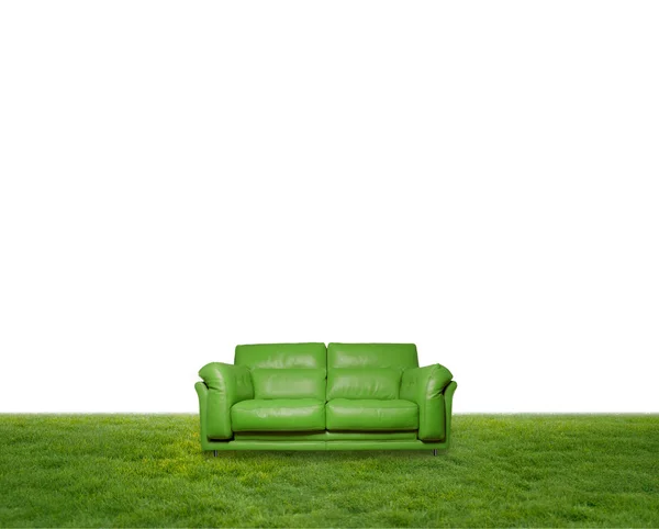 Green leather sofa on the grass — Stock Photo, Image