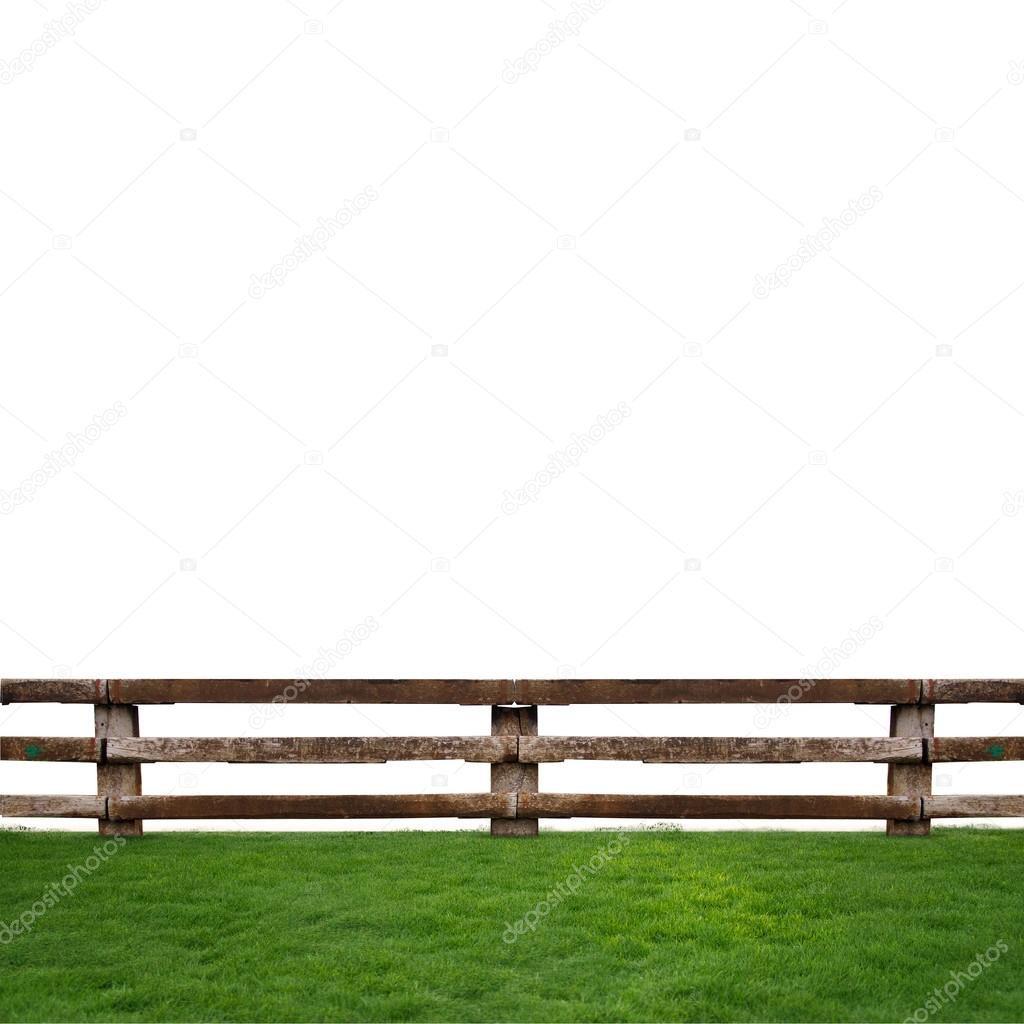 Wooden fence in green grass meadow